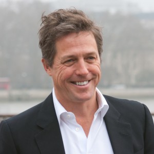 Hugh Grant smiles at a charity photo call in London